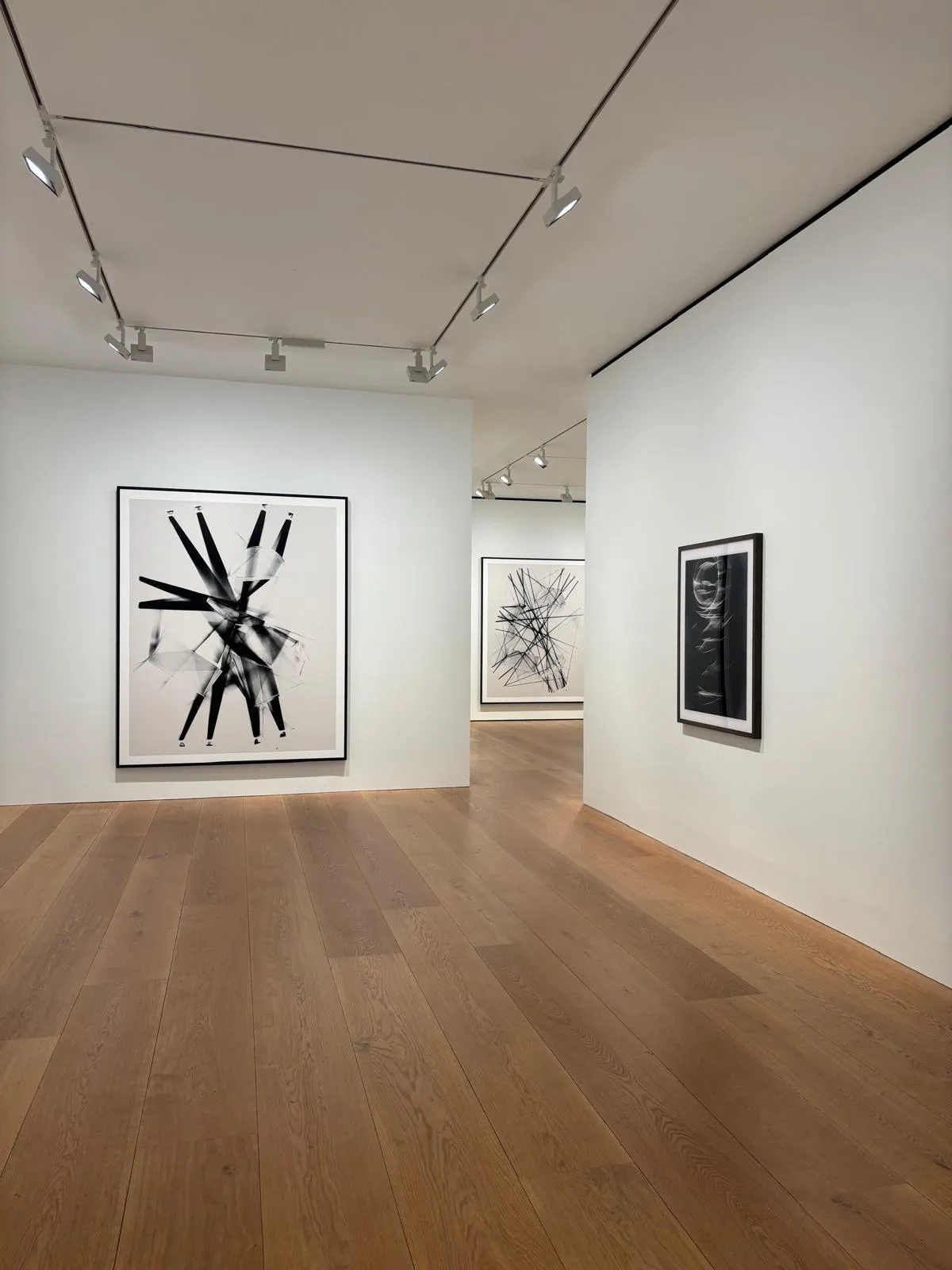 Contemporary art gallery interior with framed works on white walls